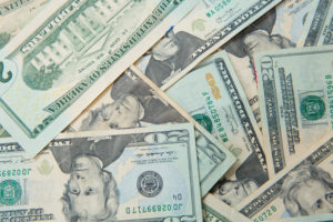 American currency - many twenty dollar bills in a pile
